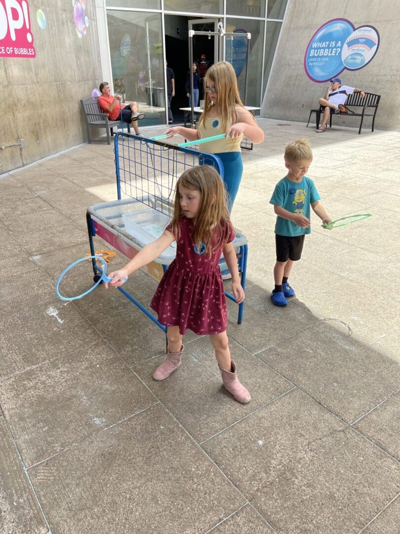 A little girl holding onto a tennis racket