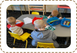 A group of children sitting at a table.